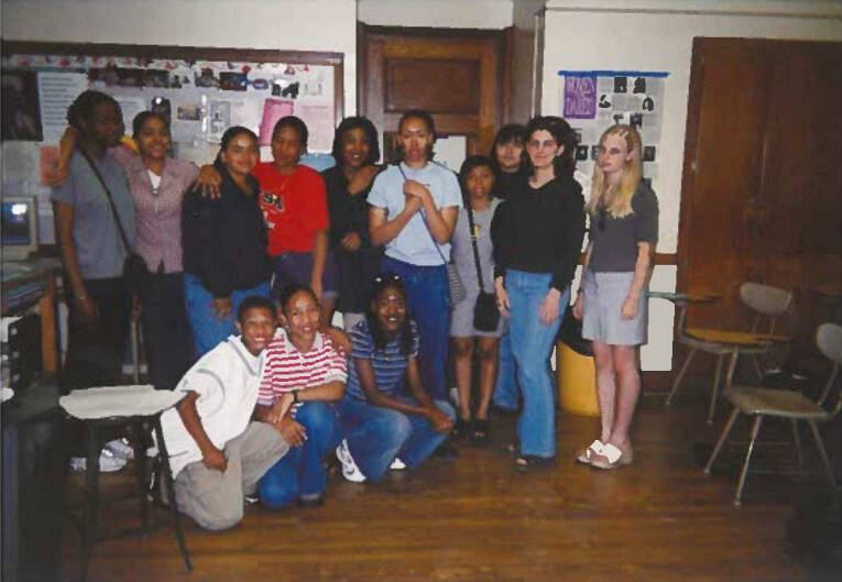 Students posing in a classroom looking at camera